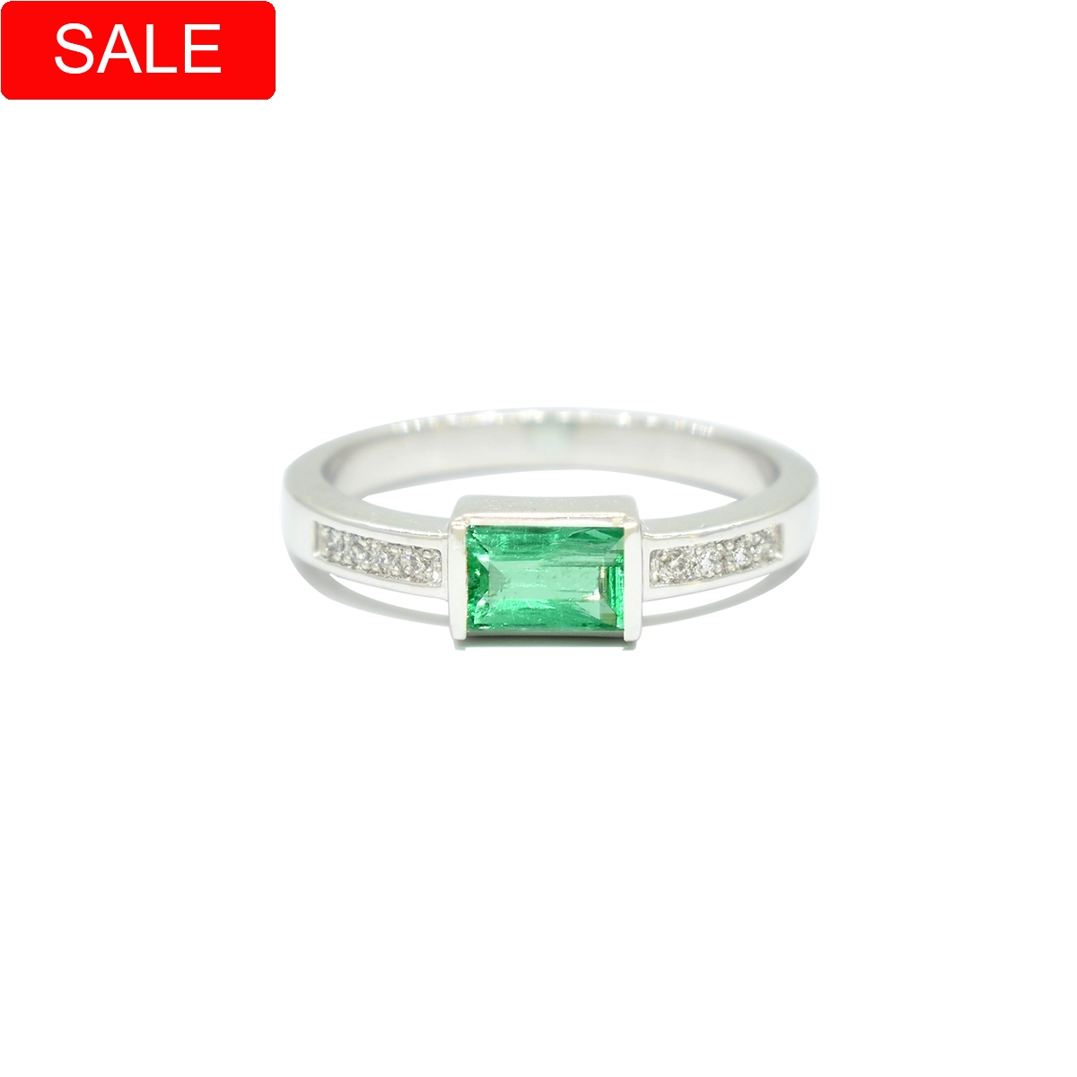 Emerald and diamond ring custom-made in 18K white gold with 0.38 carats emerald cut natural Colombian emerald and 8 round cut diamonds in 0.04 carats