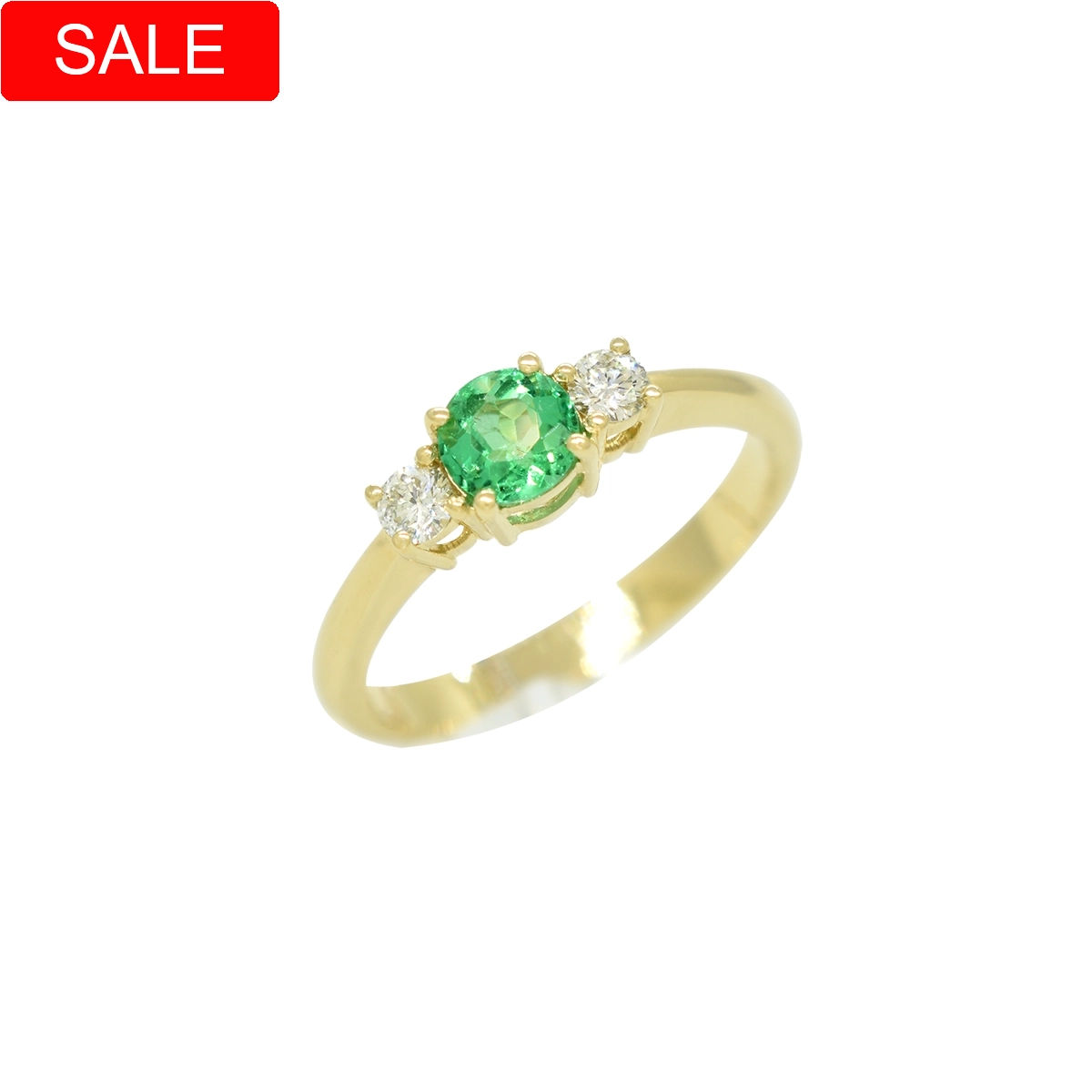 Small emerald and diamond ring in solid 18K gold with round natural Colombian emerald as the center stone flanked by 2 round cut diamonds set in fine prongs